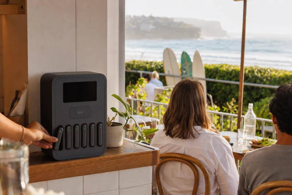 A coastal café patio with a MaxCharge station by the door